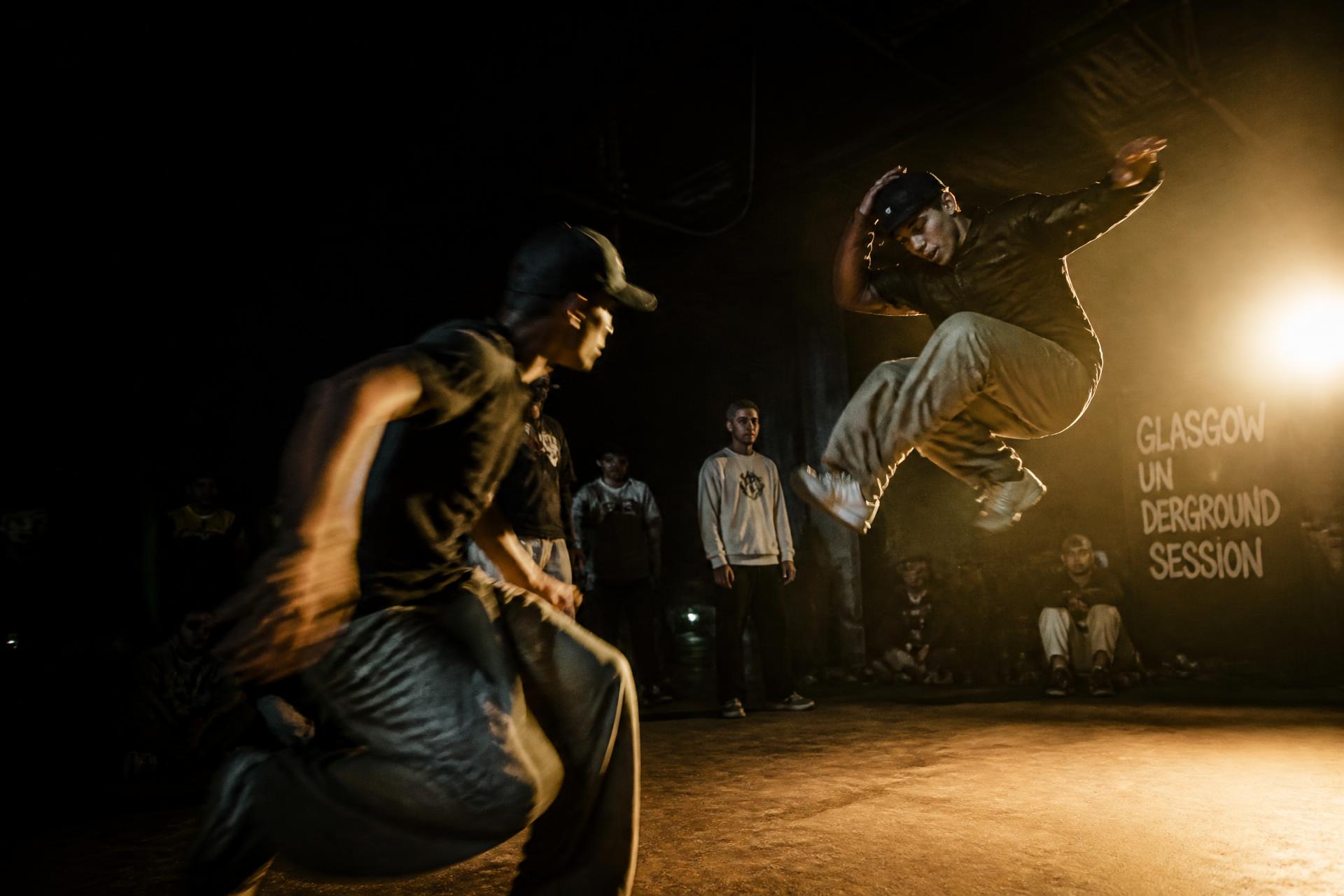 Hip hop dancers mid-battle in a Glasgow underground session